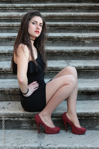 Young woman in tight black dress