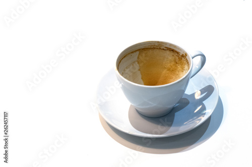 An empty coffee cup with coffee stains at the bottom of the cup after finish drinking. Dirty cup on on white background.