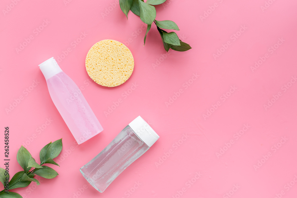 facial tonic, lotion and sponge for face care and plant on pink background top view mock up facial tonic, lotion and sponge for face care and plant on pink background top view mock up