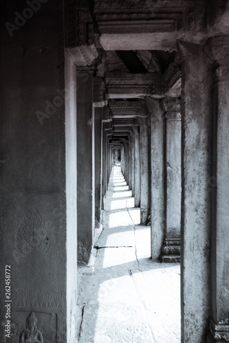 Long corridor of pillars in temple ruins  Angkor Wat in Cambodia