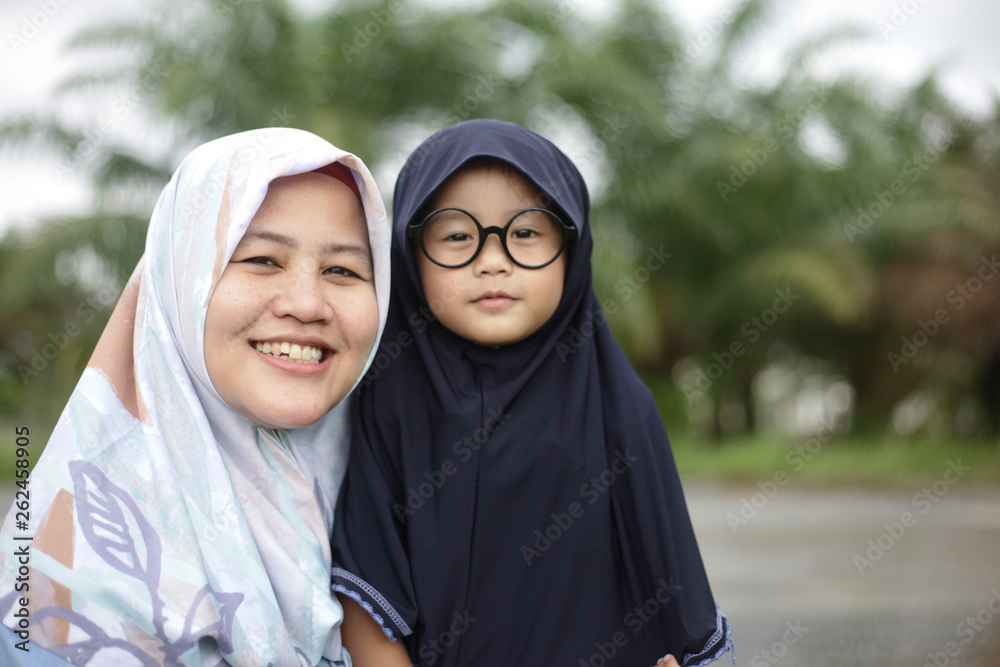 Muslim Mom and Baby Girl Playing in the Park Muslim Mom and Baby Girl Playing in the Park