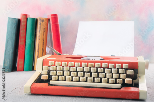Typewriter on the table with books