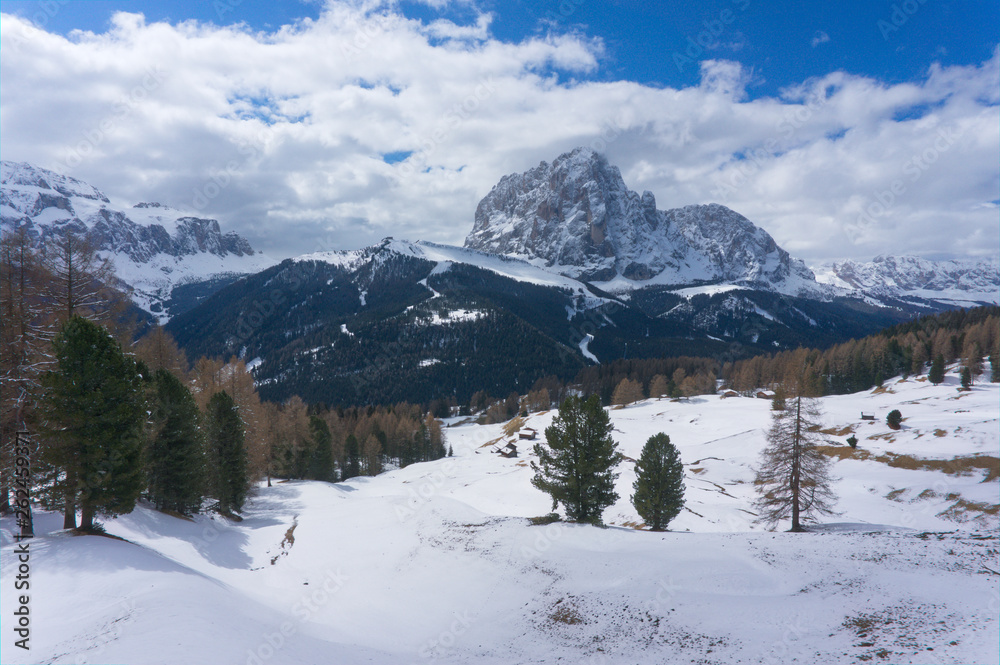 Langkofel mountain near wolkenstein in winter with snow and ice, giant rock, Sasso Piato in the Dolomites Alps, Italy