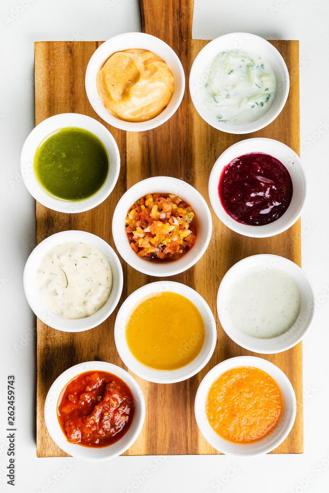 Bowls with sauces on wooden tray Bowls with sauces on wooden tray