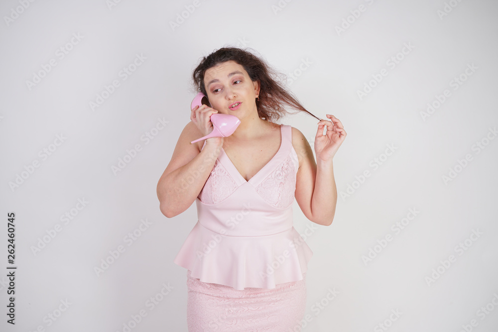 cute emotional adult girl pulls a strand of hair on white background in Studio cute emotional adult girl pulls a strand of hair on white background in Studio