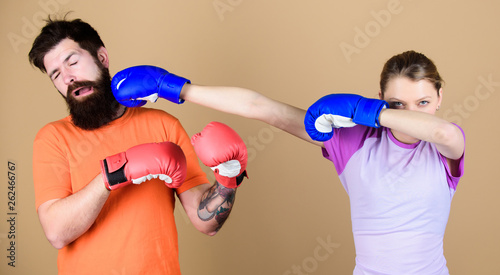 punching, sport Success. sportswear. Fight. training with coach. knockout and energy. couple training punching in boxing gloves. Happy woman punching bearded man workout in gym. girl punching.