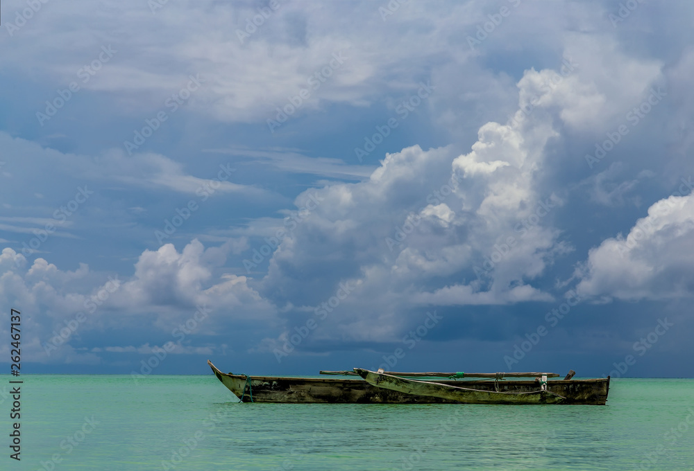 One old homemade wooden boat in  the ocean against the horizon