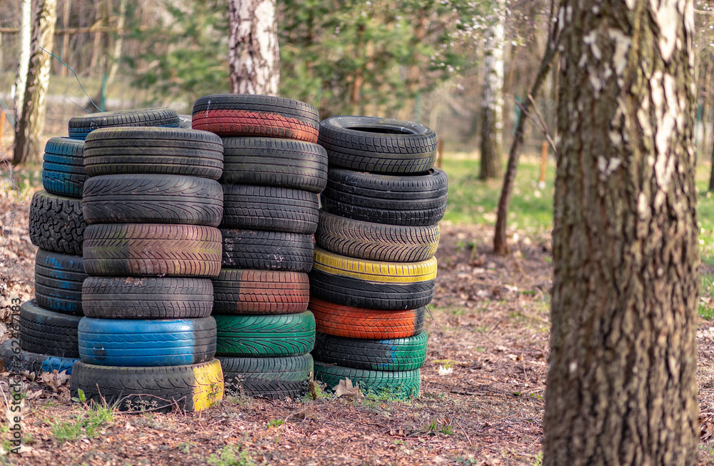 Old used car tires left, dumped in the forest, environmental concept