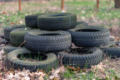 Obraz na płótnie Old used car tires left, dumped in the forest, environmental concept w salonie