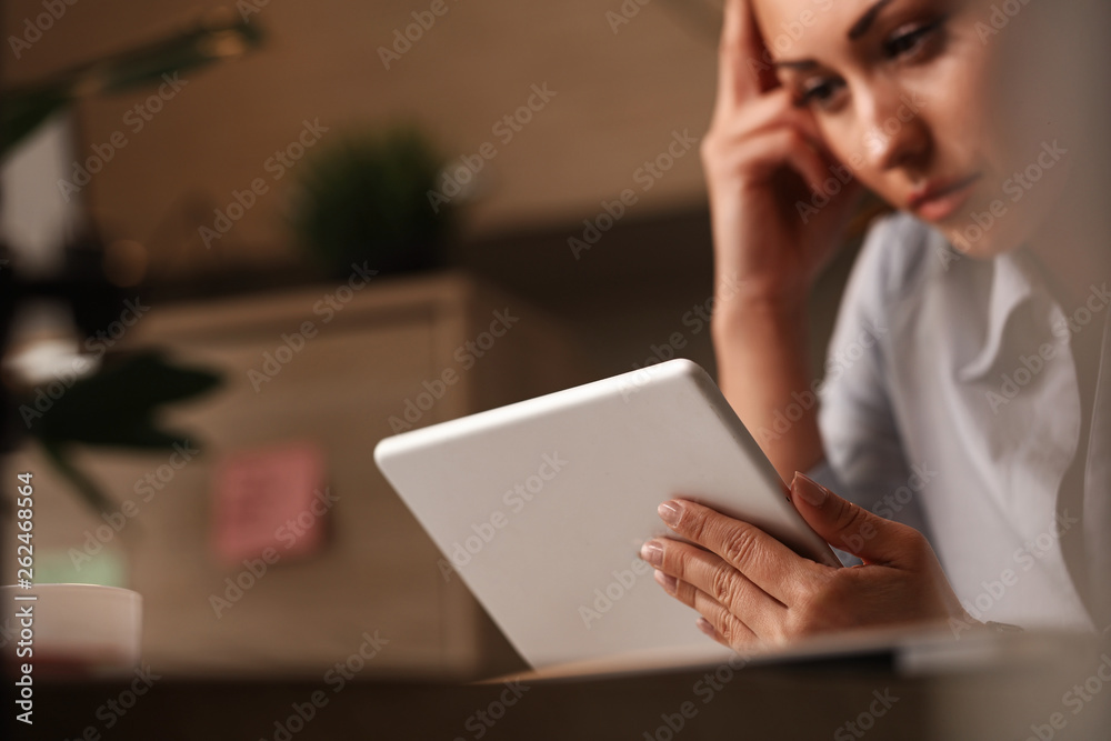 Close up of thoughtful businesswoman reading an e-mail on touchpad. Close up of thoughtful businesswoman reading an e-mail on touchpad.
