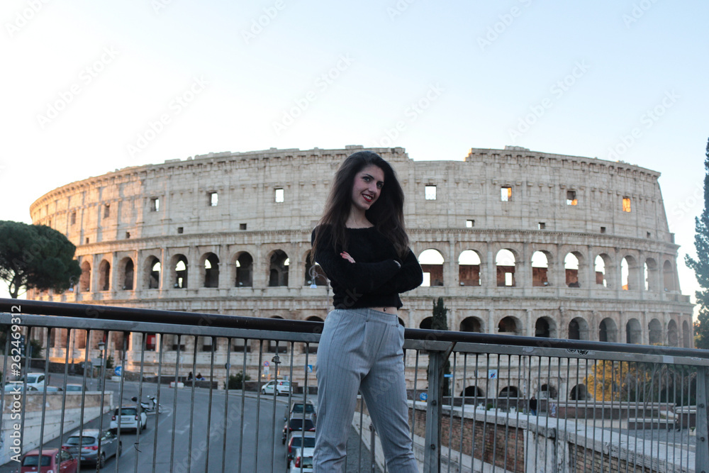 Italy travel - Young woman tourist at Coliseum, Rome.