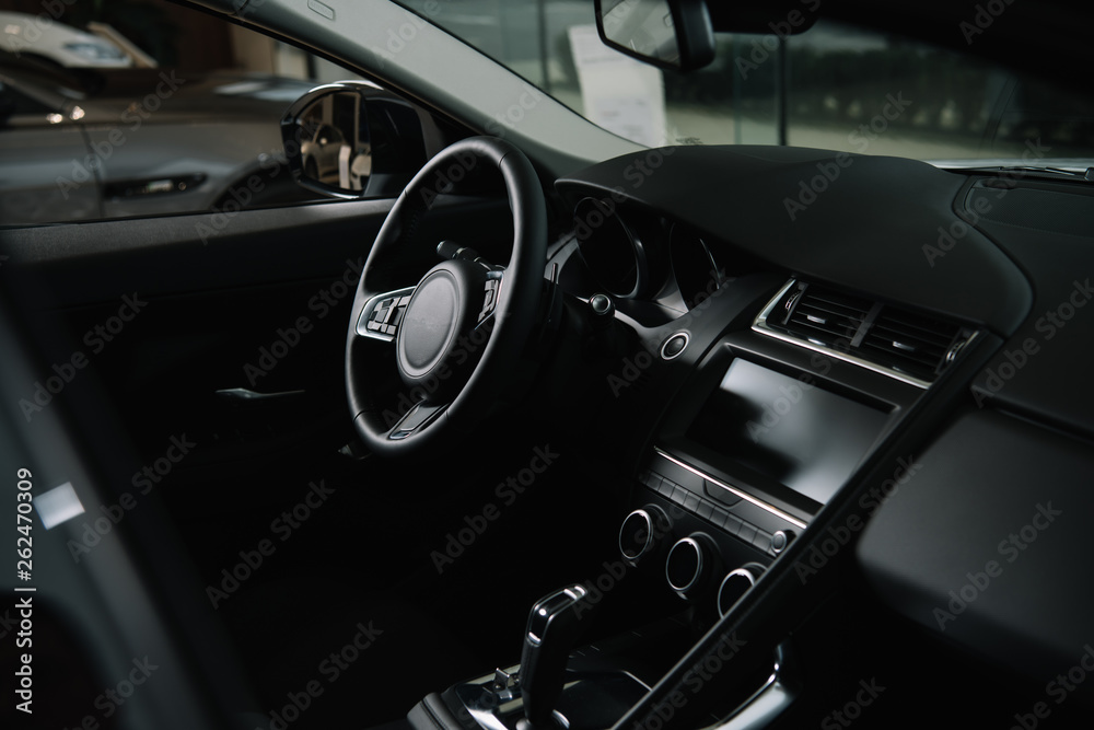 black steering wheel near gear shift in luxury car - obrazy, fototapety, plakaty 