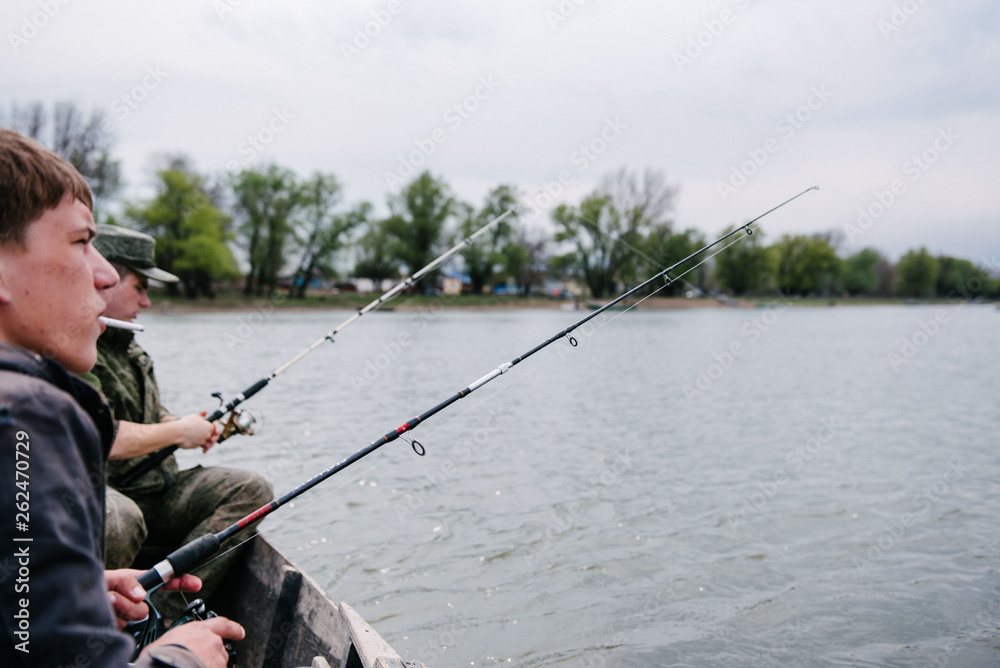 Fishermen catch fish sitting in the boat Fishermen catch fish sitting in the boat