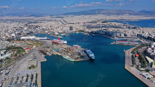 Aerial drone bird's eye view of famous crowded port of Piraeus one of the largest in Europe where ships travel to popular Aegean destinations, Attica, Greece