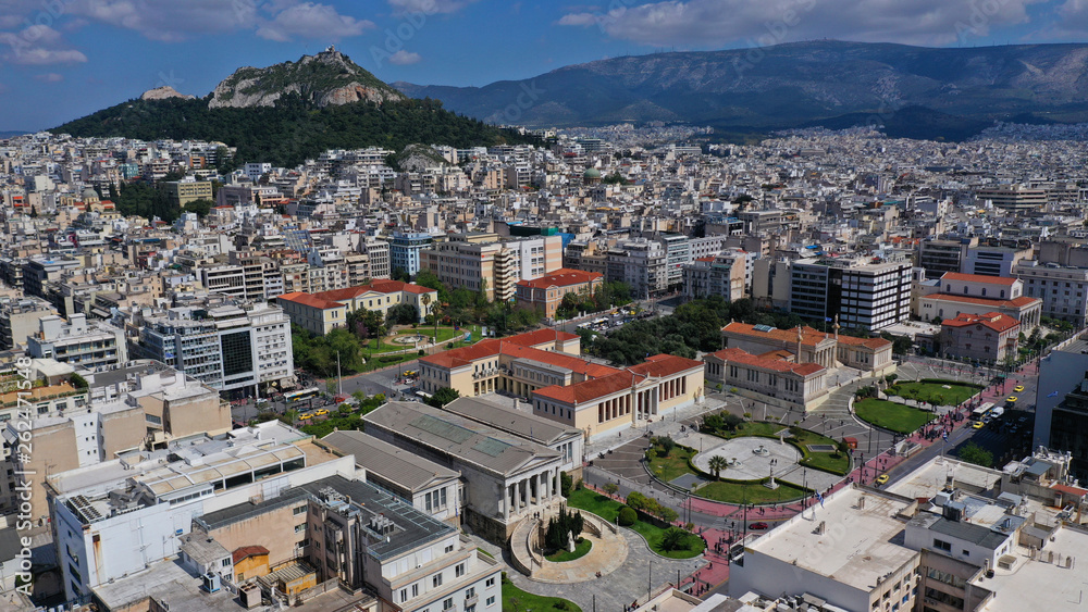 Aerial drone photo of trilogy neoclassic buildings, Academy of Athens, University and public library and Lycabettus hill at the background, Athens, Attica, Greece