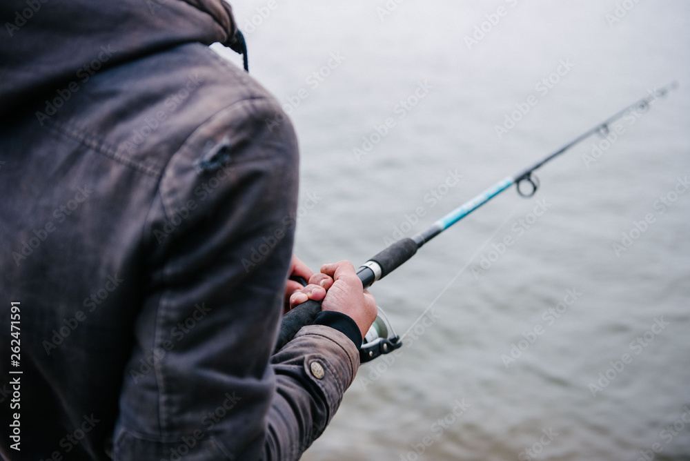 The fisherman rotates the hand reel on a spinning close-up The fisherman rotates the hand reel on a spinning close-up