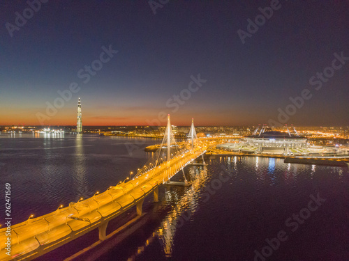 Saint-Petersburg, Russia. Aerial views to Gulf Finland. Skyscraper Lakhta center Gazprom headquarters. Stadium Zenith Arena at night. Illuminated by multi-colored lights the stadium at night. photo