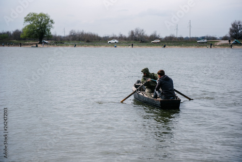 Fishermen catch fish sitting in the boat