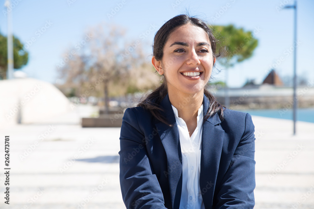 Happy confident professional enjoying walk on promenade