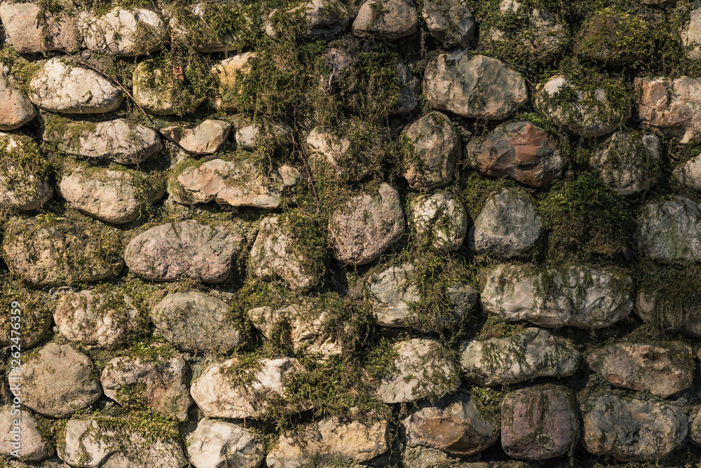 Old moss covered stone wall - beautiful vintage background