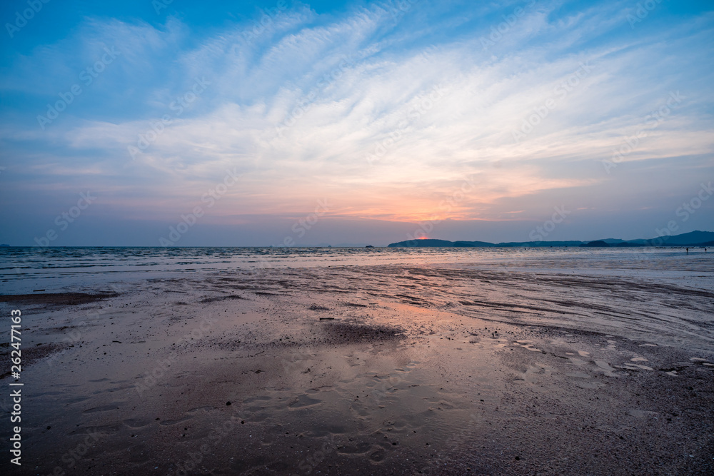 Panoramic photo of beautiful sunset over the sea with cloudy blue and orange sky