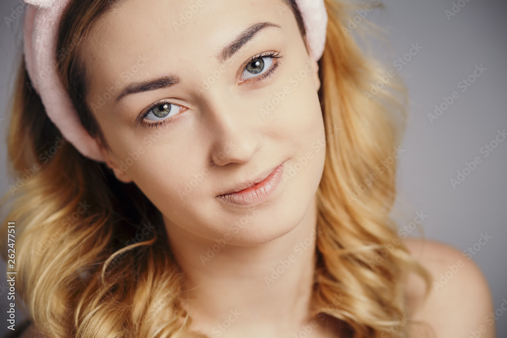 portrait of a beautiful girl in the process of doing a make-up on studio background, concept of cosmetics, lifestyle and natural beauty portrait of a beautiful girl in the process of doing a make-up on studio background, concept of cosmetics, lifestyle and natural beauty