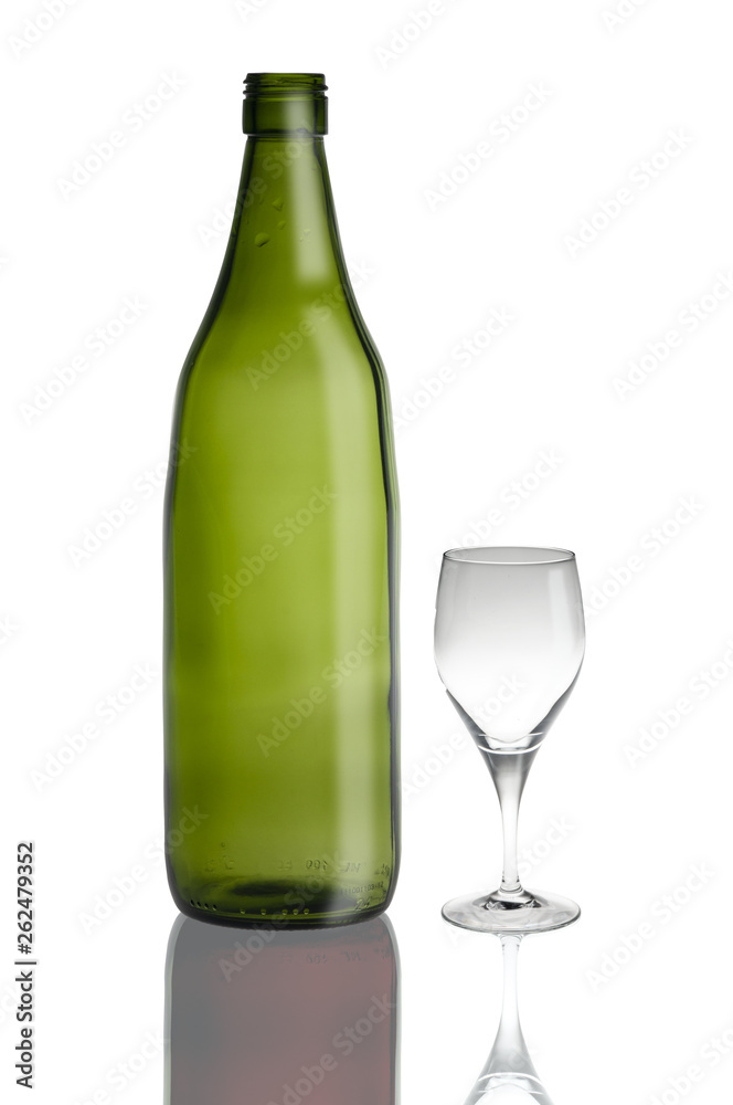 green glass bottle and glass cup isolated on white green glass bottle and glass cup isolated on white