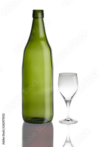 green glass bottle and glass cup isolated on white