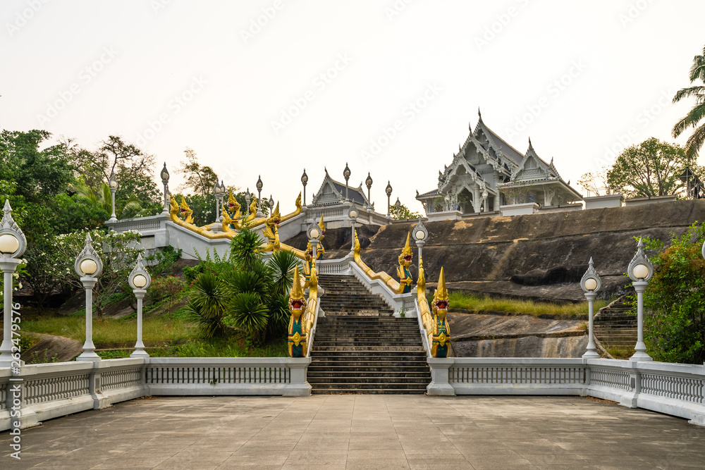 Wat Kaew Korawaram or The white temple in Krabi with grand staircase lined by naga sculptures. Clean white sky Wat Kaew Korawaram or The white temple in Krabi with grand staircase lined by naga sculptures. Clean white sky