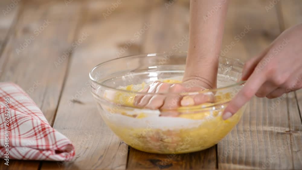 Baking concept. Cook hands kneading dough in a glass bowl. Baking concept. Cook hands kneading dough in a glass bowl.