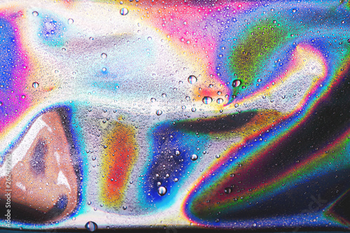 Drops of water on vibrant holographic neon background