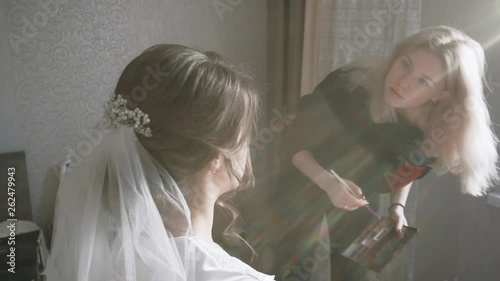 makeup artist girl preparing for the wedding bride