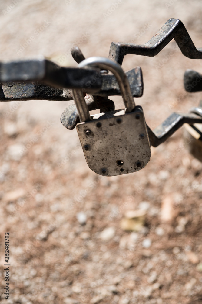 rusty chain and padlocks hanging on bridge in Brugge, Bruges, Belgium rusty chain and padlocks hanging on bridge in Brugge, Bruges, Belgium