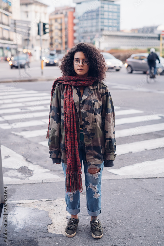 young curly girl standing in the street young curly girl standing in the street