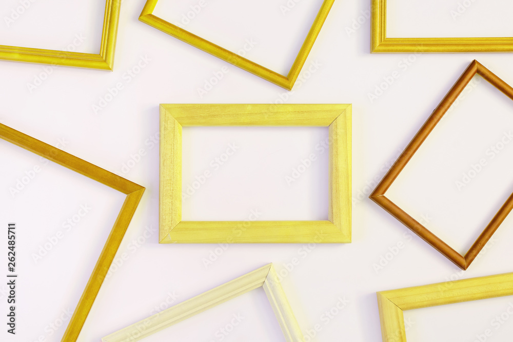 On a white background many yellow empty frames are laid out. Space for text, layout. Unusual concept.