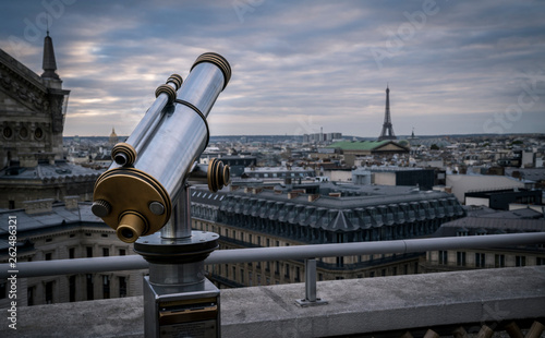 A tower viewer on the roof of the shopping center Galeries Lafayette in Paris, France. In the background is the Eiffel Tower.