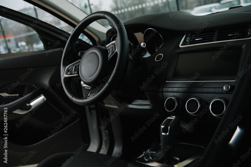 black steering wheel near manual transmission in luxury car