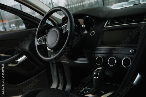 black steering wheel near manual transmission in luxury car © LIGHTFIELD STUDIOS