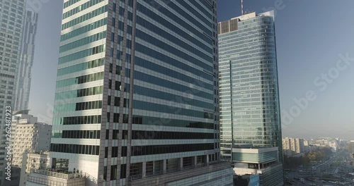 Drone footage of a side movement between skyscrapers and glass office buildings in Warsaw.