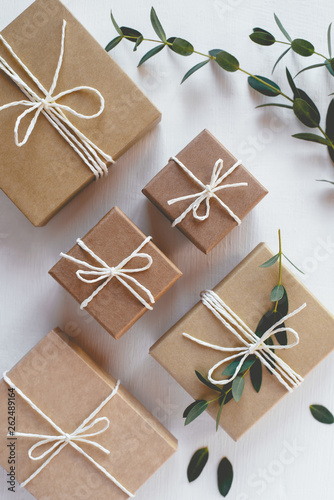 Craft gift boxes on white wooden background. Flat lay