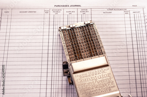 vintage adding machine on ledger purchases journal page