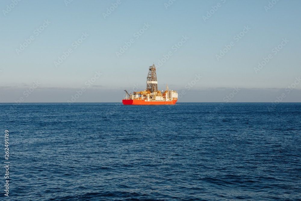 offshore oil and gas drillship, blue ocean background offshore oil and gas drillship, blue ocean background
