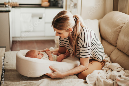 Home portrait of happy mother and newborn baby