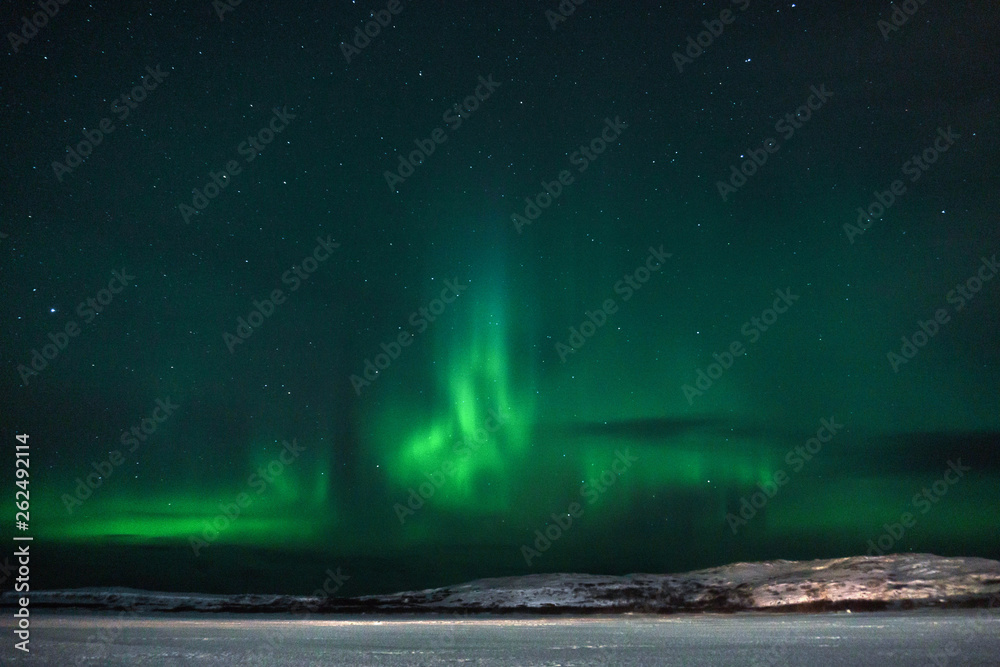 green northern lights over the tundra filmed on a long exposure in a frosty clear night