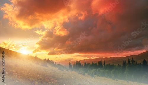 fantastic colorful landscape.  overcast clouds glowing in sunligt over the mountain meadov. picturesque nature view.