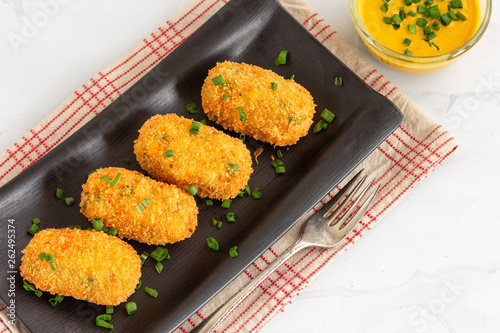 Potato Croquettes with Cheese Served with Mustard Sauce on White Background, Directly From Above, High Angle View .Photo. Vegetarian Appetizer, Snack, Deep Fried Food Conceopt.. photo