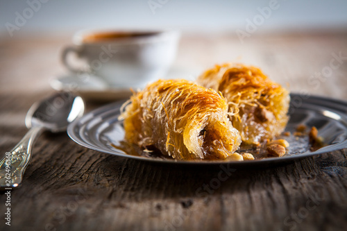 greek kataifi on a silver plate with greek coffee on the background photo