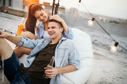 Happy couple enjoying drinks and balcony party. © NDABCREATIVITY