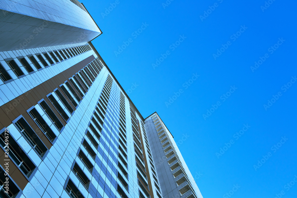 multistory building against the blue sky, bottom view multistory building against the blue sky, bottom view