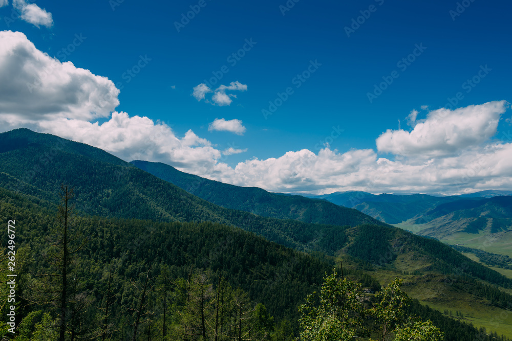 Spectacular landscape overlooking the green valley in the mountains. Journey in the mountains of Altai. Sunny summer day.